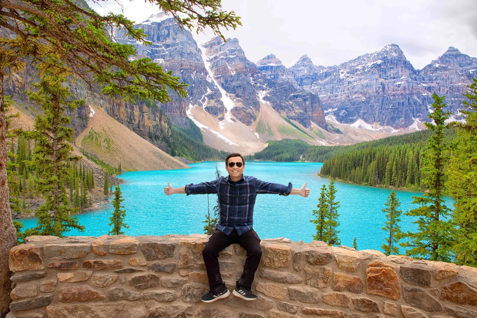 Khánh Nguyễn beside a turquoise lake in the Canadian Rockies